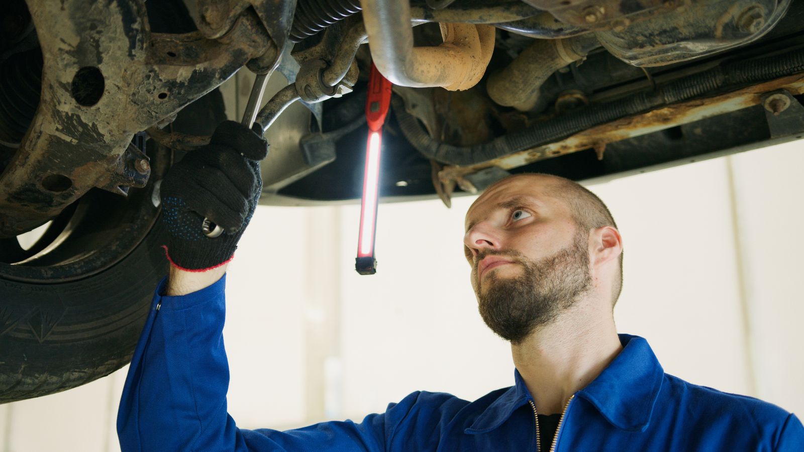 Mechanic using a wrench while repairing a car
